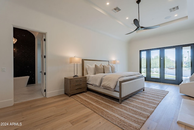 bedroom with access to exterior, french doors, light wood-type flooring, and ceiling fan