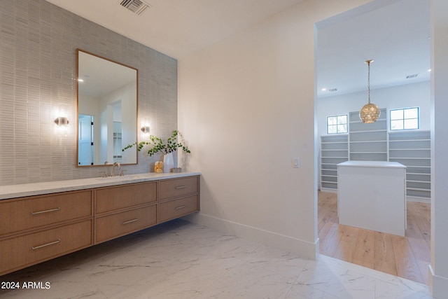 bathroom with vanity and backsplash