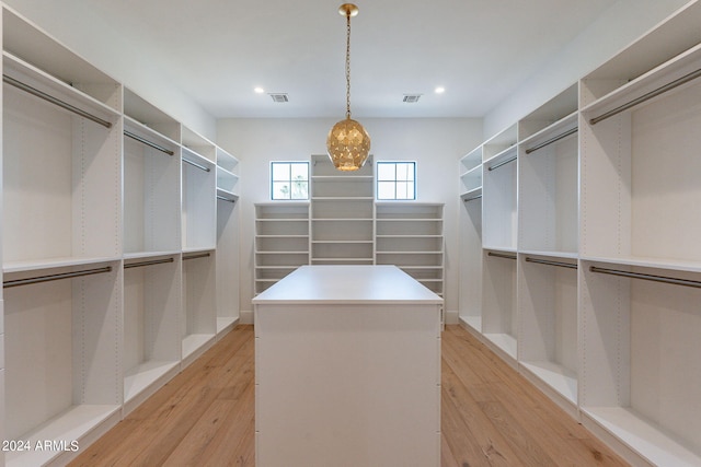 walk in closet featuring light hardwood / wood-style floors