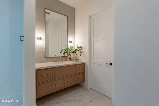 bathroom featuring decorative backsplash and vanity