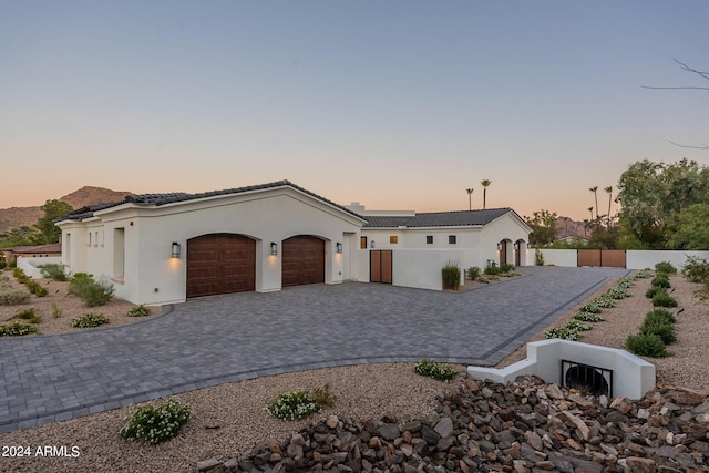 mediterranean / spanish-style house with a garage