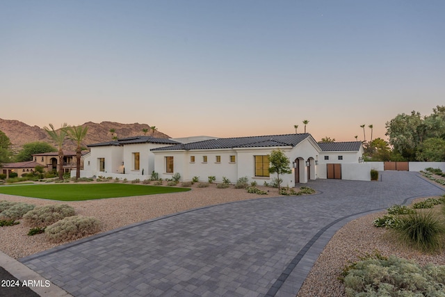 mediterranean / spanish-style house featuring a mountain view and a yard