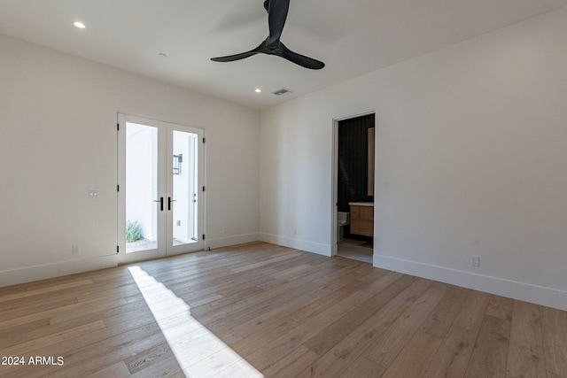 spare room featuring french doors, light wood-type flooring, and ceiling fan