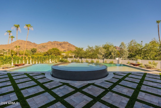 view of patio / terrace featuring a mountain view and a fenced in pool