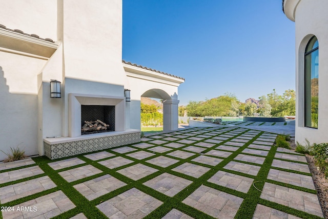 view of patio featuring a tile fireplace