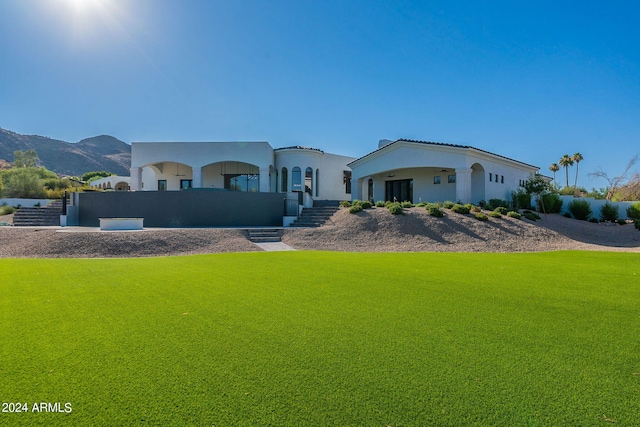 mediterranean / spanish home featuring a mountain view and a front yard