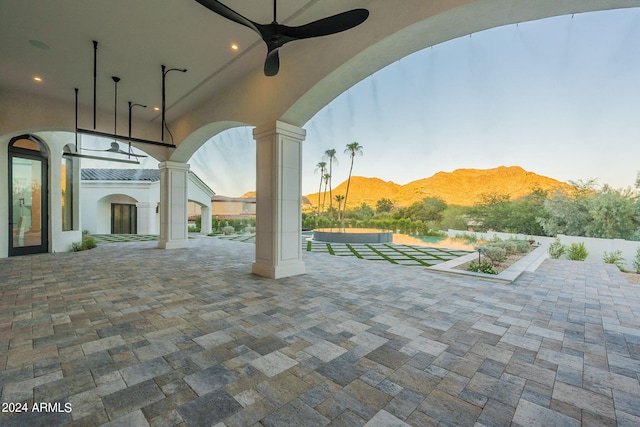 view of patio with a mountain view and ceiling fan