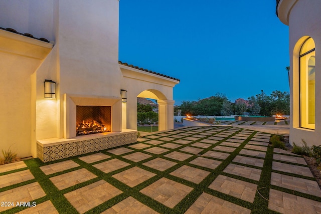 patio terrace at dusk with a fireplace