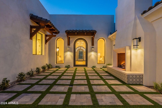 entrance to property featuring an outdoor fireplace