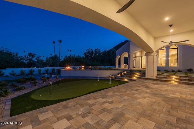 patio at twilight featuring ceiling fan