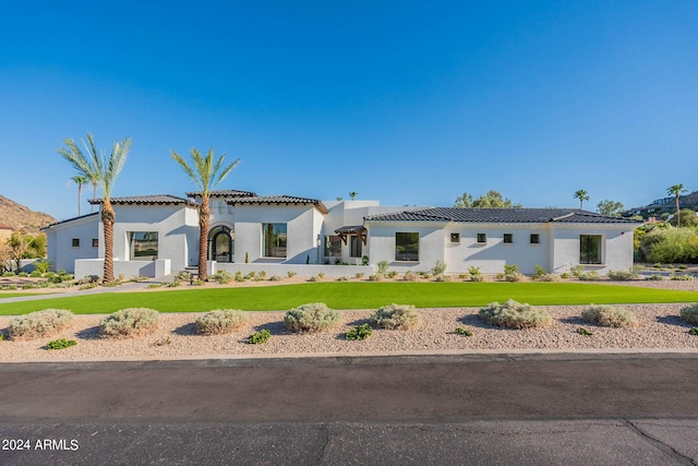 mediterranean / spanish-style house with a front lawn