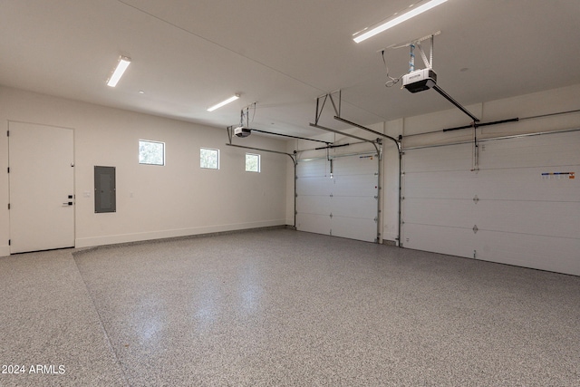 garage featuring electric panel and a garage door opener