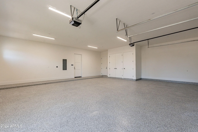 garage featuring electric panel and a garage door opener