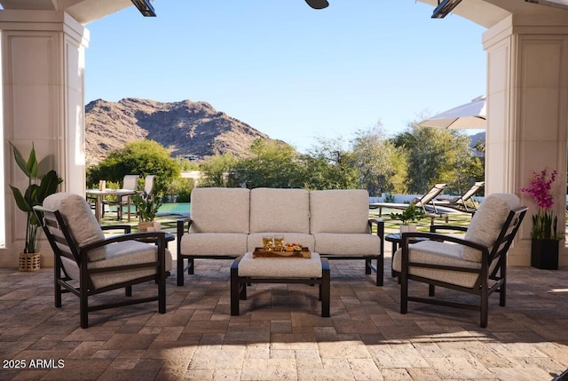 view of patio / terrace with outdoor lounge area and a mountain view