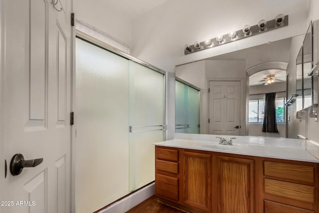 full bathroom with ceiling fan, wood finished floors, a stall shower, and vanity
