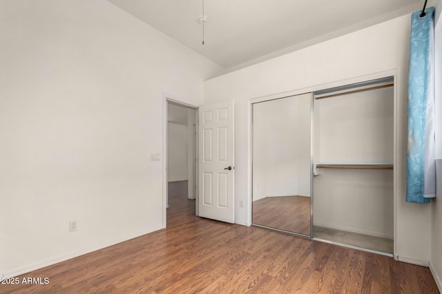 unfurnished bedroom featuring a closet and wood finished floors