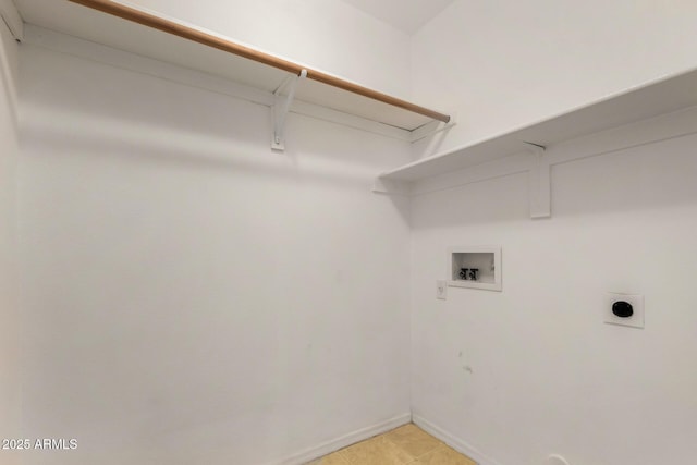 laundry room with hookup for an electric dryer, light tile patterned floors, baseboards, laundry area, and washer hookup