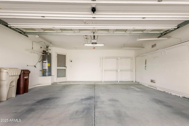 garage with visible vents, gas water heater, and a garage door opener