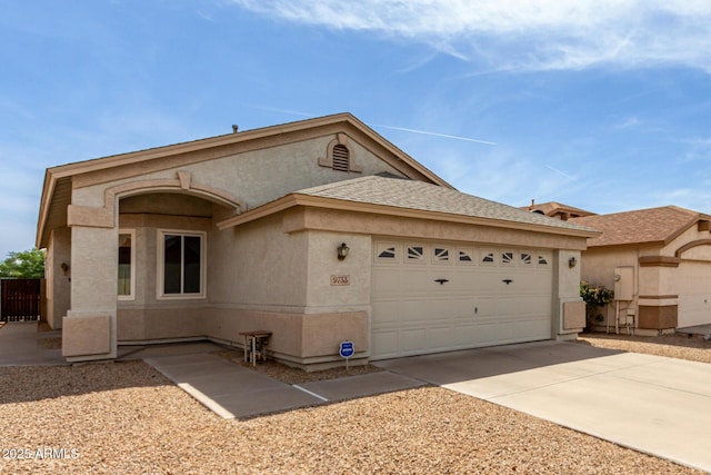 ranch-style home featuring stucco siding, a garage, and concrete driveway