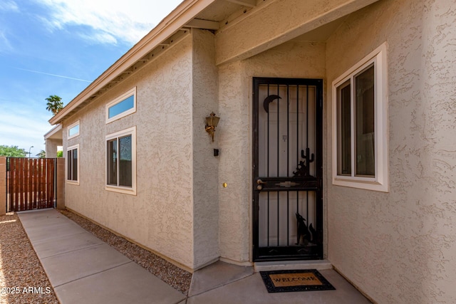 property entrance featuring stucco siding