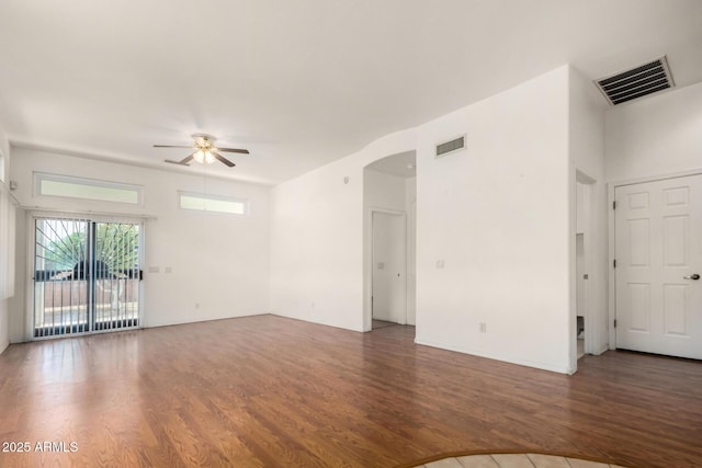 empty room featuring visible vents, wood finished floors, and a ceiling fan