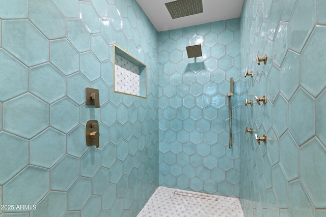 bathroom with a tile shower