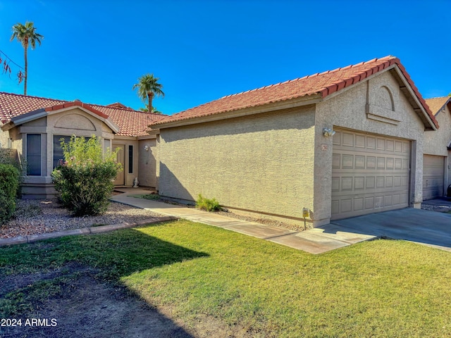 view of front of property featuring a garage and a front lawn