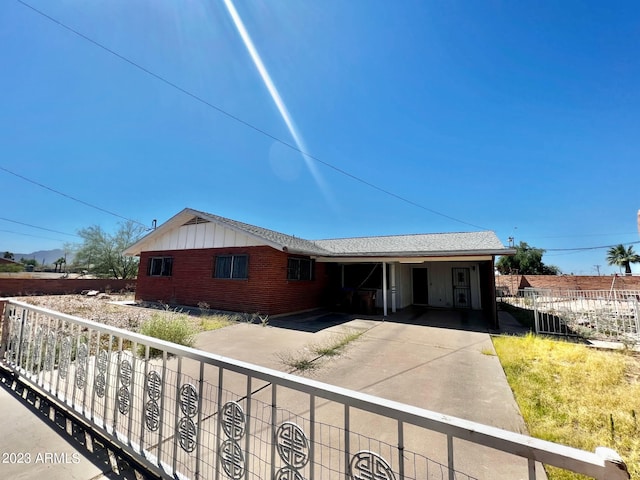 ranch-style home featuring a carport