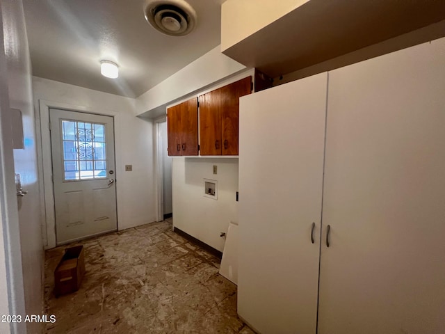 clothes washing area with cabinets, washer hookup, and light tile floors
