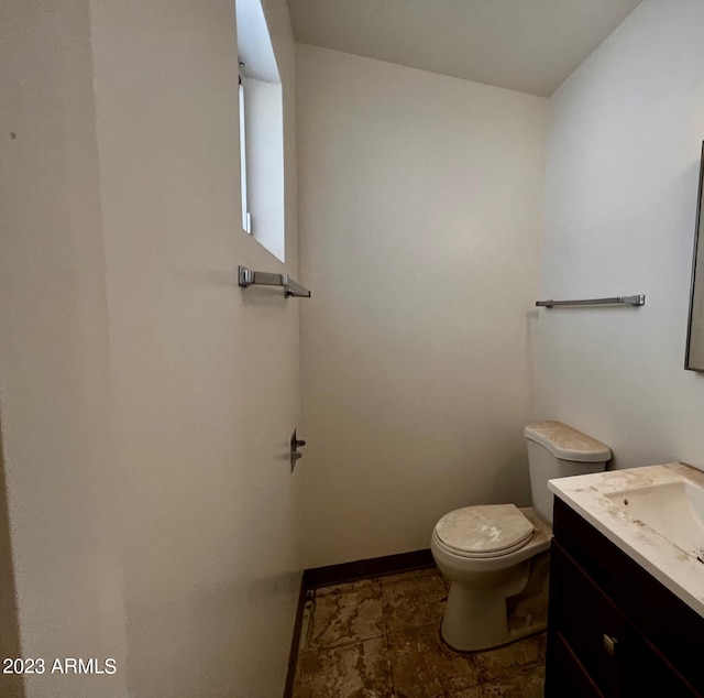 bathroom featuring tile floors, toilet, and vanity