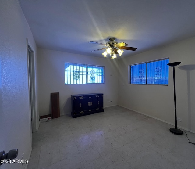 interior space featuring light tile flooring and ceiling fan