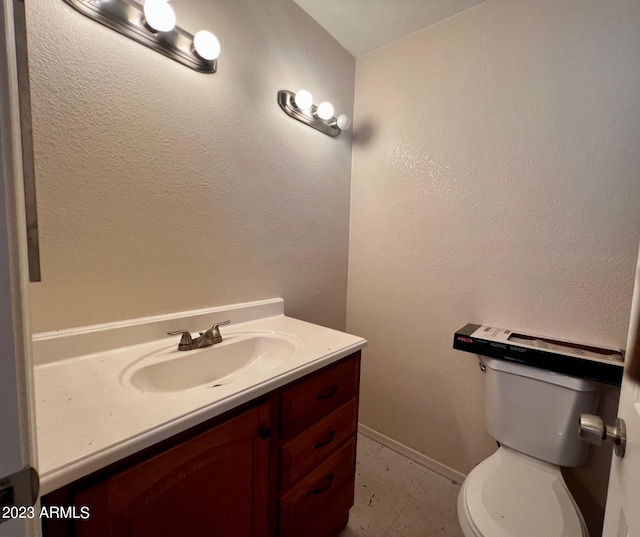 bathroom with tile flooring, toilet, and vanity