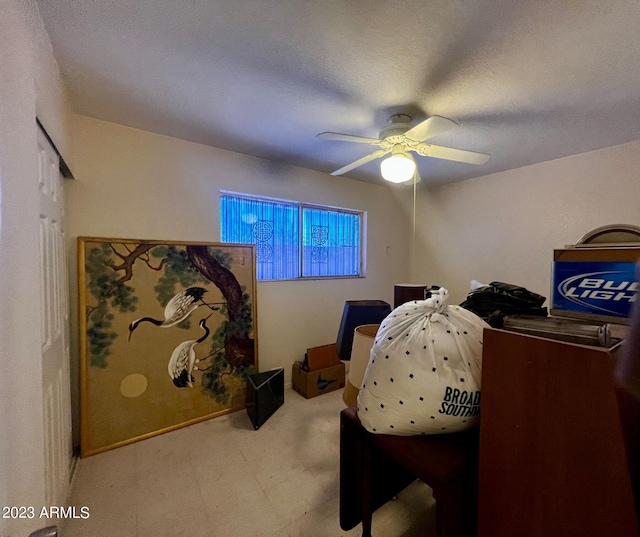 bedroom with a textured ceiling, light colored carpet, and ceiling fan