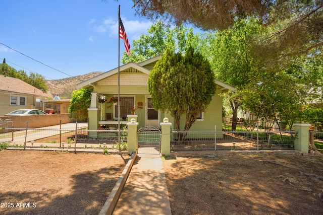 24 Black Knob Vw, Bisbee, AZ 85603 - view of front facade with a porch, a fenced front yard, and a gate