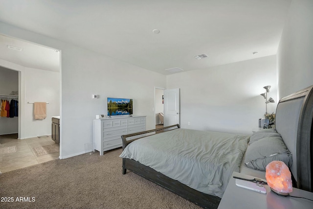 carpeted bedroom with a spacious closet