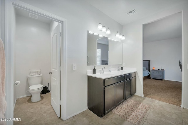 bathroom featuring vanity, toilet, and tile patterned flooring