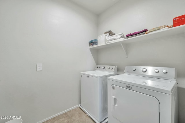 laundry room featuring washing machine and clothes dryer and light tile patterned floors