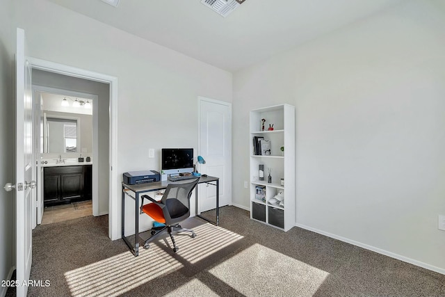 office space with sink and dark carpet