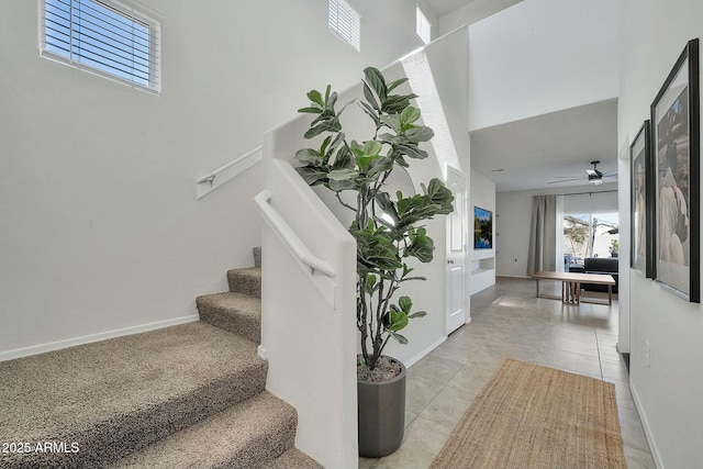 staircase with tile patterned flooring and ceiling fan