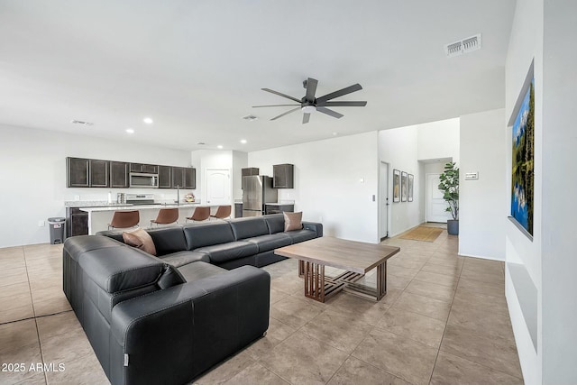 living room featuring light tile patterned flooring and ceiling fan