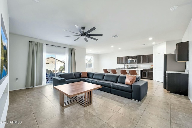 tiled living room with ceiling fan