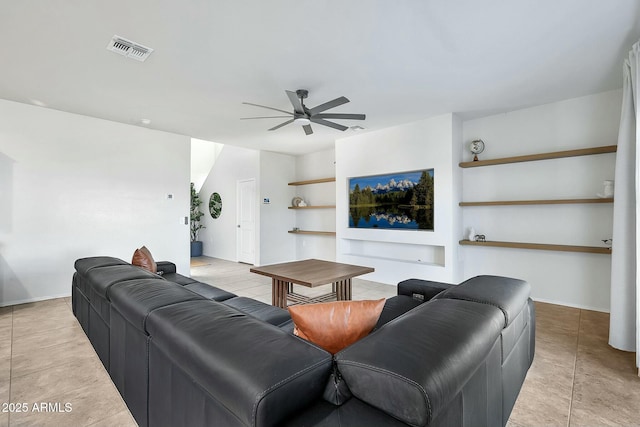 living room with built in features and ceiling fan