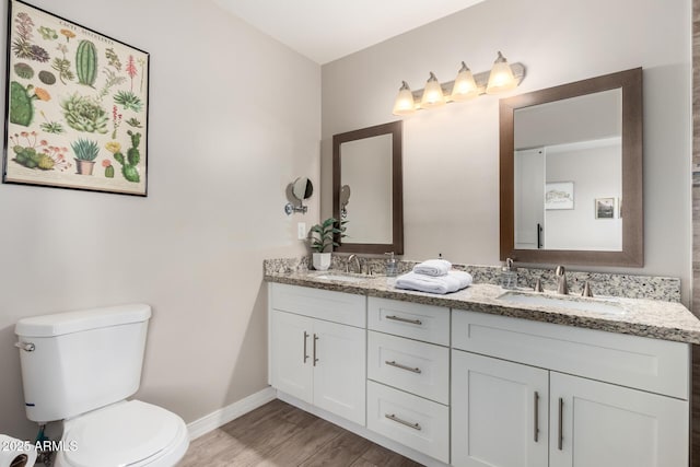 508 S Ernie Pl, Tempe, AZ 85281 - bathroom with a sink, baseboards, toilet, and wood finished floors