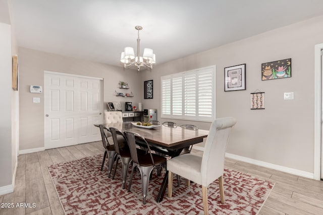 508 S Ernie Pl, Tempe, AZ 85281 - dining space with baseboards, a notable chandelier, and light wood-style flooring