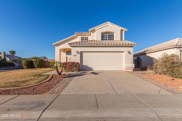 mediterranean / spanish-style home with a garage and a front lawn