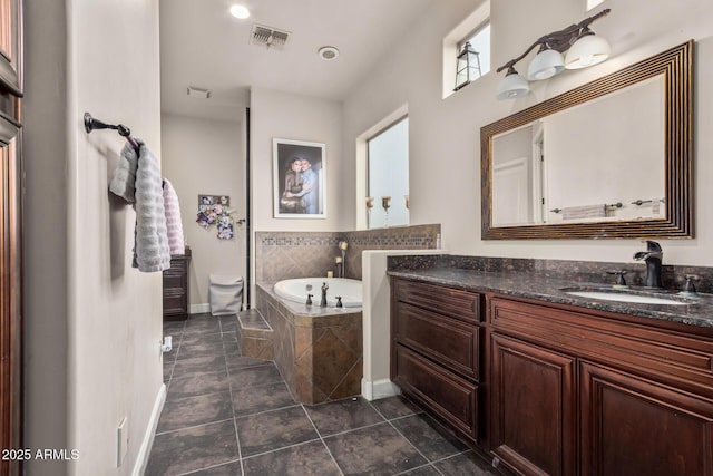 full bathroom featuring visible vents, baseboards, a garden tub, tile patterned floors, and vanity