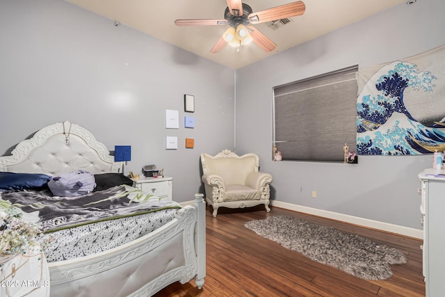 bedroom with a ceiling fan, visible vents, wood finished floors, and baseboards