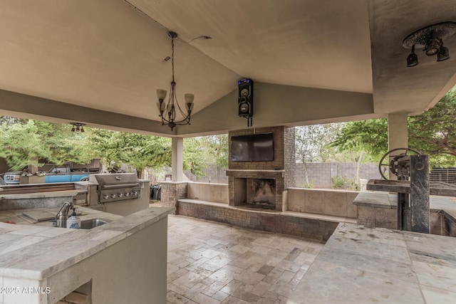 view of patio with grilling area, fence, an outdoor fireplace, area for grilling, and a sink