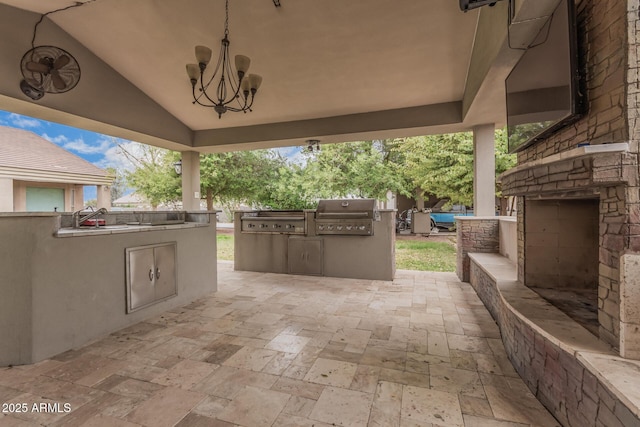 view of patio / terrace with area for grilling, an outdoor kitchen, and an outdoor stone fireplace