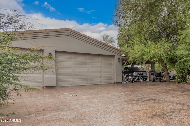 garage with decorative driveway